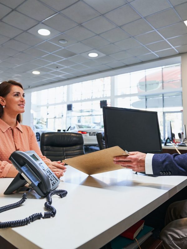 Friendly conversation in the car dealership office